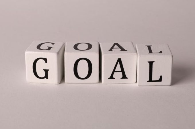 White letter blocks spelling 'Goal' on a neutral backdrop, ideal for business themes.